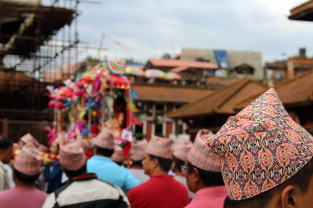 the "dhaka topi" worn by local nepali people who are having a festival around patan durbar square - dhaka topi imagens e fotografias de stock