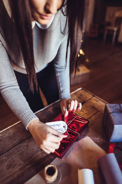 istock woman making the package for the christmas gift 1056909286
