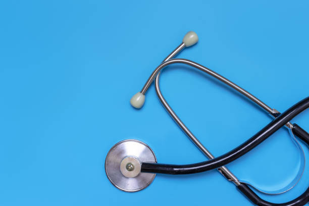 istock Stethoscope on blue background with copy space,flat lay, top view. Doctor and treatment concept 1056914034