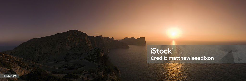 Holiday sunset Beautiful sunset over the protected peninsular of Formentor in Majorca. Stitched panorama detailed when viewed large. Bay of Water Stock Photo