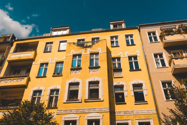 istock yellow apartment building with white ornaments and darken sky 1056915738