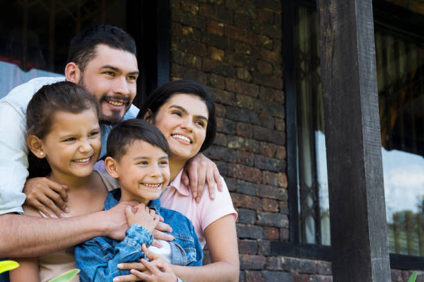 istock Family sitting outside their house 1056917458