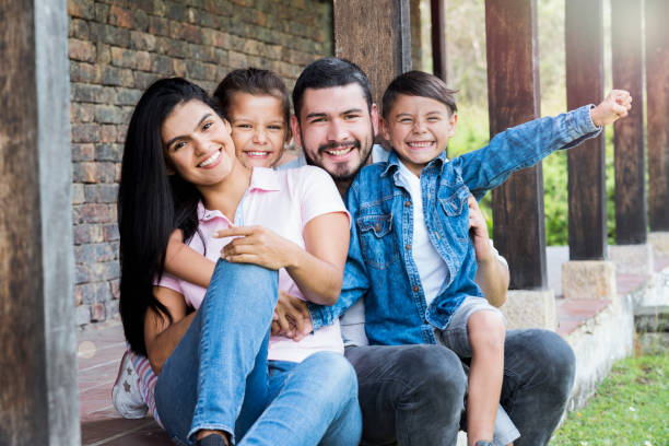 istock Family sitting outside their house 1056917594
