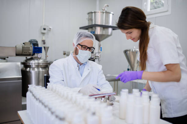 Technologist and his assistant testing quality of cosmetic products.