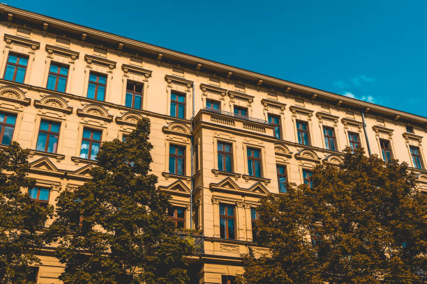 istock vintage colored apartment building with darken trees in the foreground 1056921336