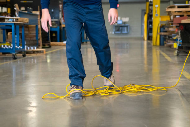 istock A worker tripping over an electrical cord in an industrial environment 1056925688