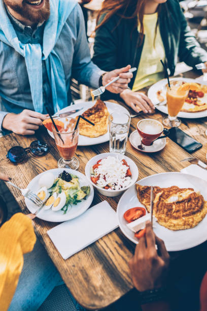istock Group of friends eating at a restaurant 1056925792