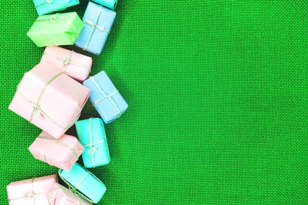 istock Boxes with gifts on a green background fabric texture 1056926028