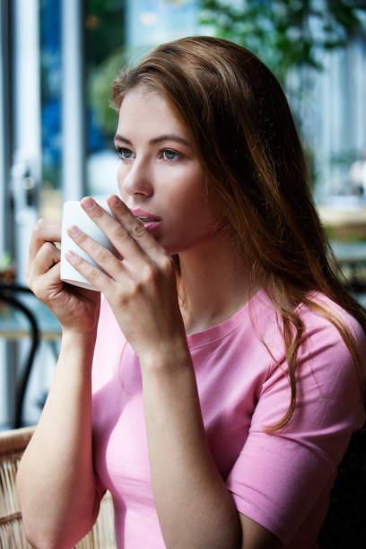 istock a pretty woman drinking coffee 1056926380