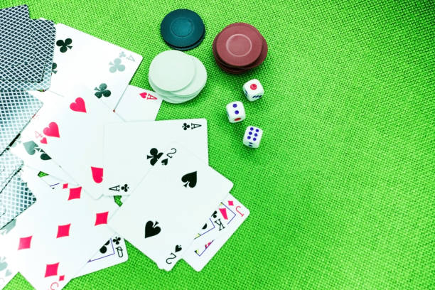 istock Poker cards on a green table with dice and chips 1056926418
