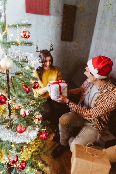istock exchanging the christmas presents at home 1056926426