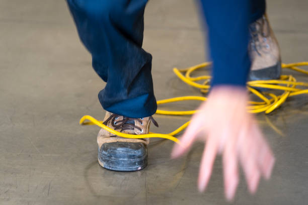 istock A worker tripping over an electrical cord in an industrial environment 1056926530
