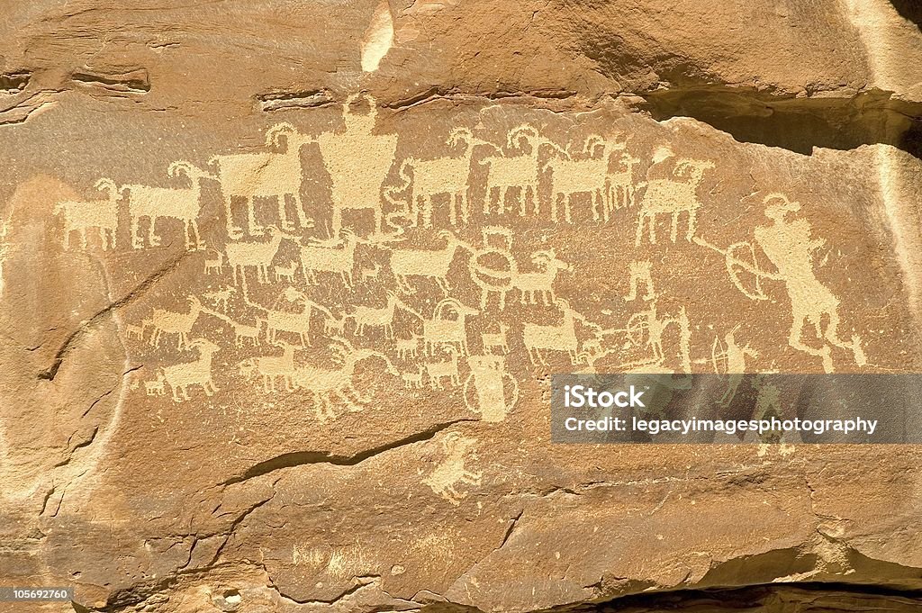 Hunter Panel Famous Indian Petroglyph from Nine Mile Canyon Fremont Indian petroglyph in Nine Mile Canyon (near Price, Utah) featuring hunters with bows and arrows, a horned shamanic figure, and a shield figure in the middle of the bighorn sheep. Interpretations of the panel have been centered around bringing good luck to the hunt or describing a particularly plentiful hunt. Ancient Stock Photo