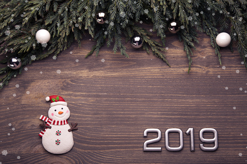 Christmas, New Year, holiday  background. Funny snowman, brunch christmas tree.