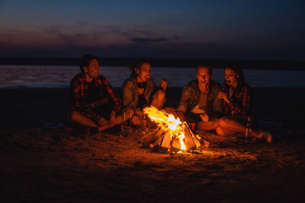 istock young friends have picnic with bonfire on the beach 1056937810