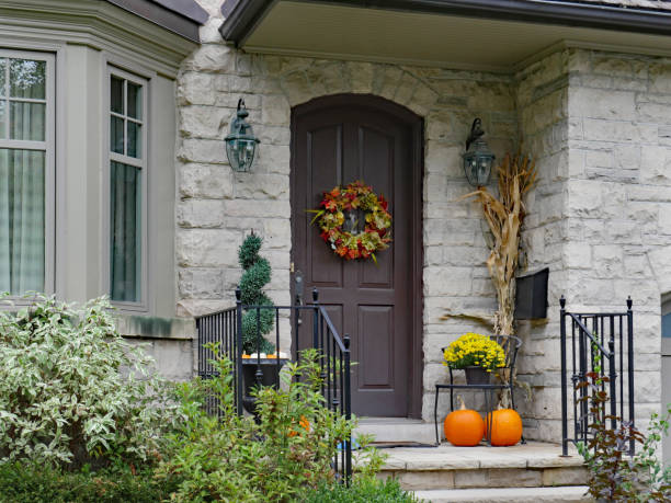 istock front door of stone house with pumpkins 1056939218