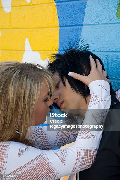 Young Couple Kissing In Front Of A Grafitti Wall Stock Photo - Download Image Now - Adult, Affectionate, Beautiful People