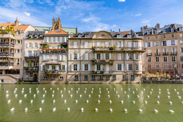 METZ, FRANCE - AUG 27, 2018: folded small plastic ships cover the moselle at Metz in an organized structured way. The city is covered with art projekts during the fannual estival Mirabeau.