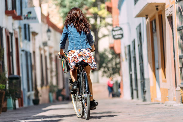 istock Young woman commuting on bicycle 1056944502