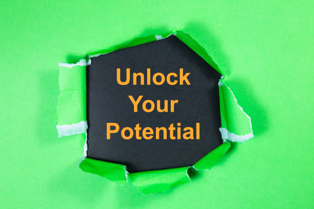 istock unlock your potential text on paper. Word unlock your potential on torn paper. Concept Image. 1056945408