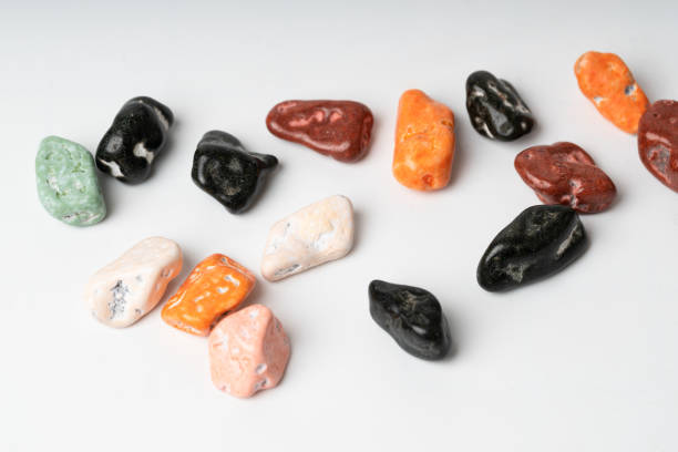 istock colorful chocolate candy stone spread on white background 1056954458