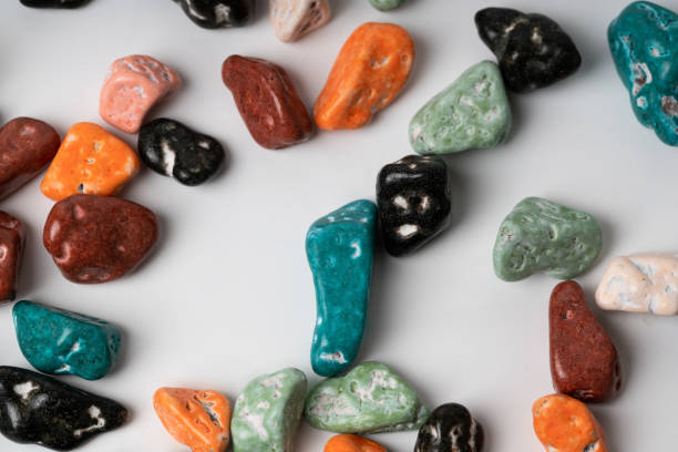 istock colorful chocolate candy stone spread on white background 1056955322