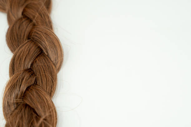 istock Braided brown human hair, tangled and left aligned. Isolated on white background 1056964090