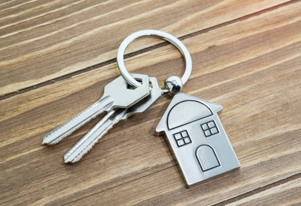 istock House Key And Key chain On Wooden Table 1056964502