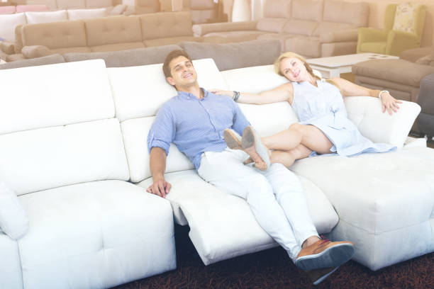 istock Young couple admire new sofa-transformer 1056974832