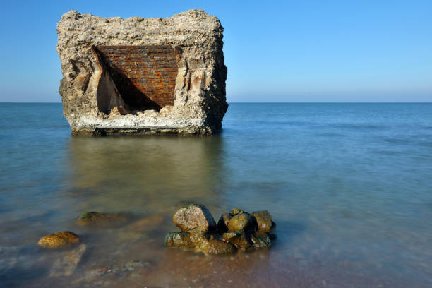 Ruins of bunker on the beach of the Baltic sea, part of an old fort in the former Soviet base Karosta in Liepaja, Latvia