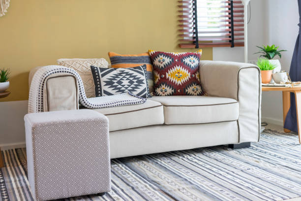 istock Native american pattern pillow on beige sofa in living room. 1056977770