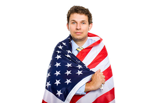 istock young businessman wrapped in american flag, isolated 105698009