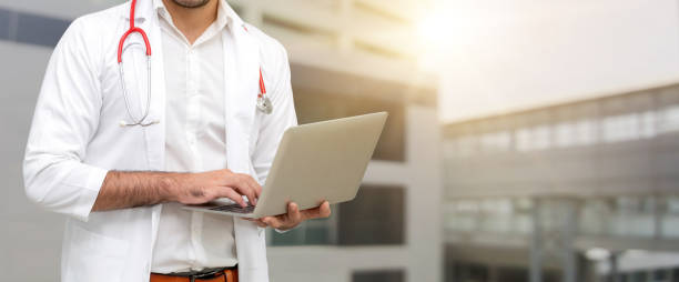 istock Doctor using laptop computer at the hospital. 1056983162