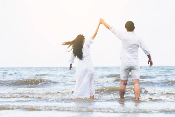 istock Couple going honeymoon on tropical beach in summer 1056986314