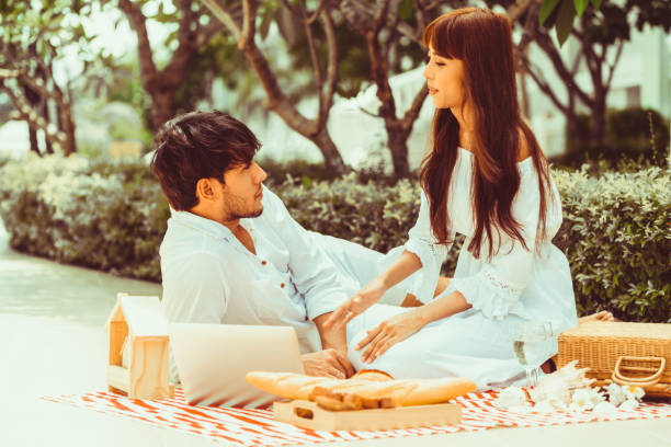 istock Young couple go picnic at the park in summer. 1056987420