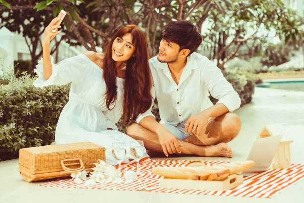 istock Young couple go picnic at the park in summer. 1056987436