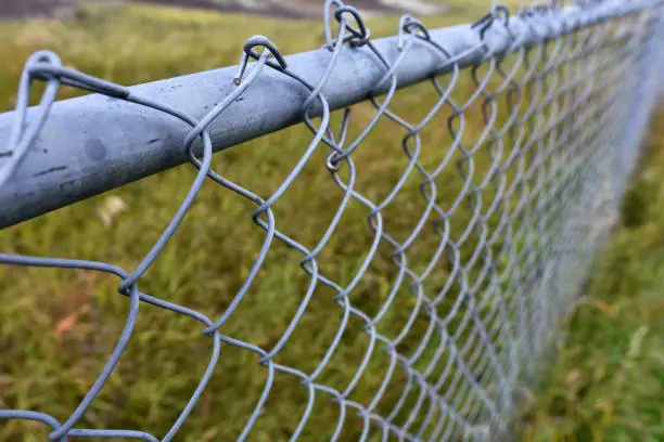 An abstract image of a metal chain link fence.