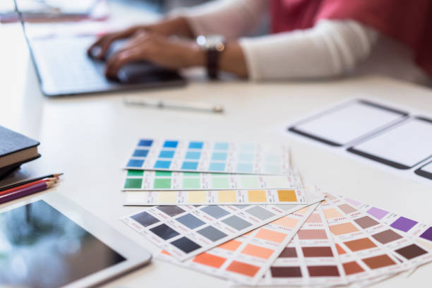 istock Young designers teamwork working with color samples for selection on office desk, Architects choosing color samples for design project,creative graphic design working desk. 1056990804