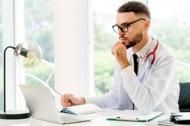 istock Doctor working on laptop computer hospital. 1056991692