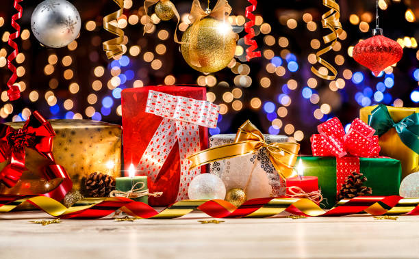 istock Colorful Christmas presents on defocused Christmas lighting background with copy space 1056991754