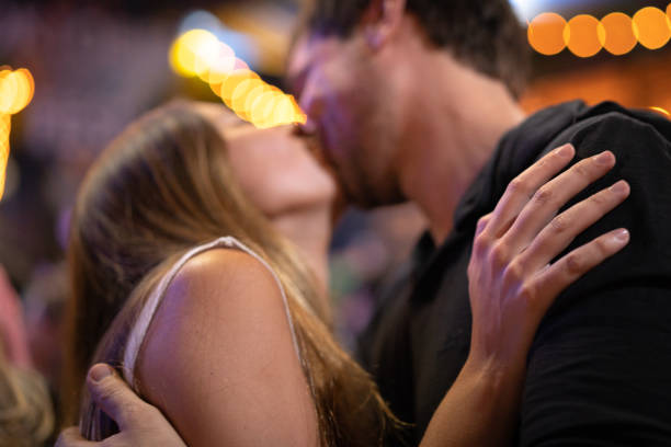 istock Couple Kissing at Party 1056993810