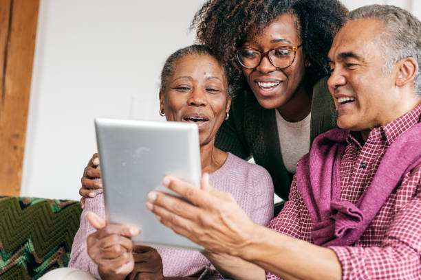istock Grandparents and their daughter with tablet 1056995906