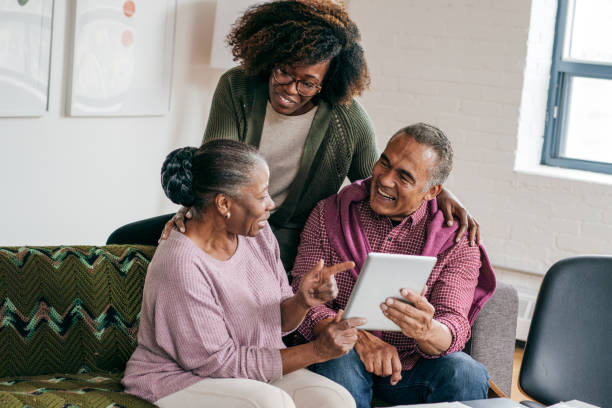 istock Grandparents and their daughter with tablet 1056995914