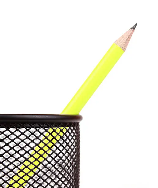 yellow pen in black penholder isolated on white background