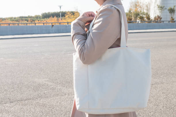 istock Woman holding white canvas bag 1057009600