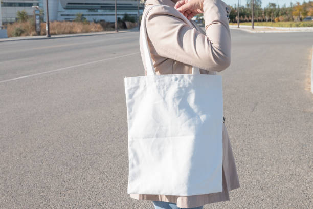 istock Woman holding white canvas bag 1057009606