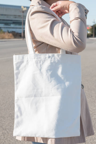 istock Woman holding white canvas bag 1057009654
