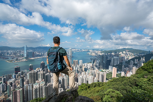 A man stood on the top of the mountain of  Hong Kong