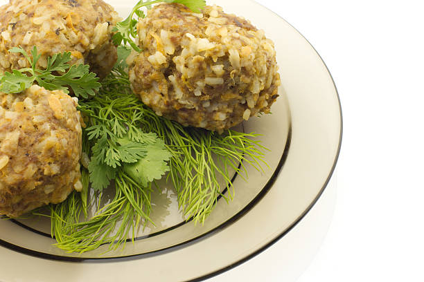 Rissoles with rice served with dill and coriander, white background