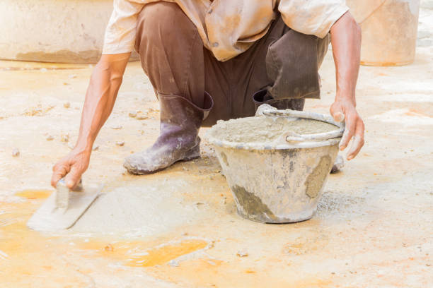 istock construction workers were plastering repair floor in workplace build a house with copy space add text 1057042484